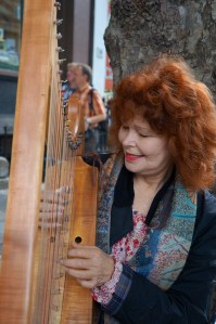 harpist playing the pachelbel on Dame Stteet for change