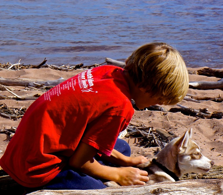 Eli in the labyrinth with a puppy who stopped by for a visit
