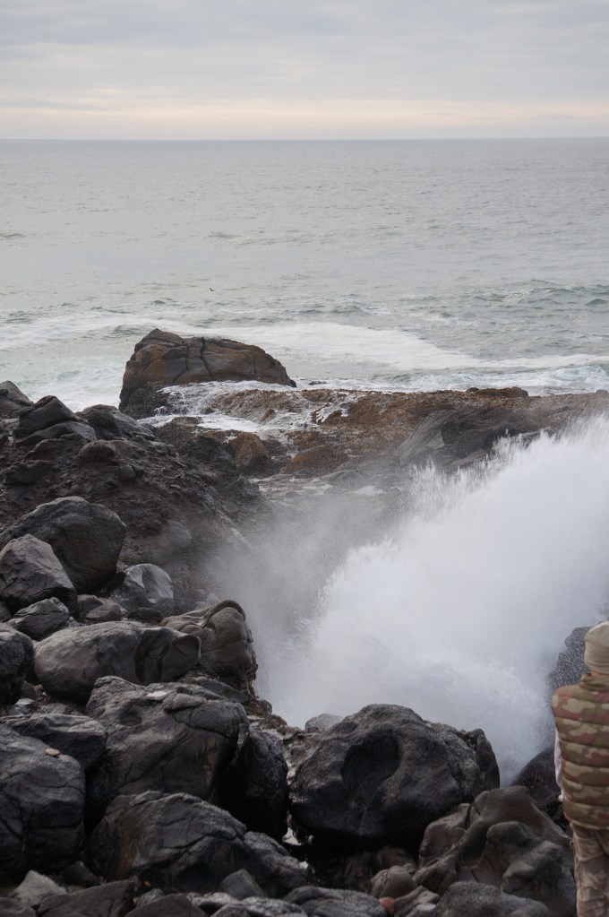 water Kaaa-thumping through a narrow passageway and erupting out a blowhole